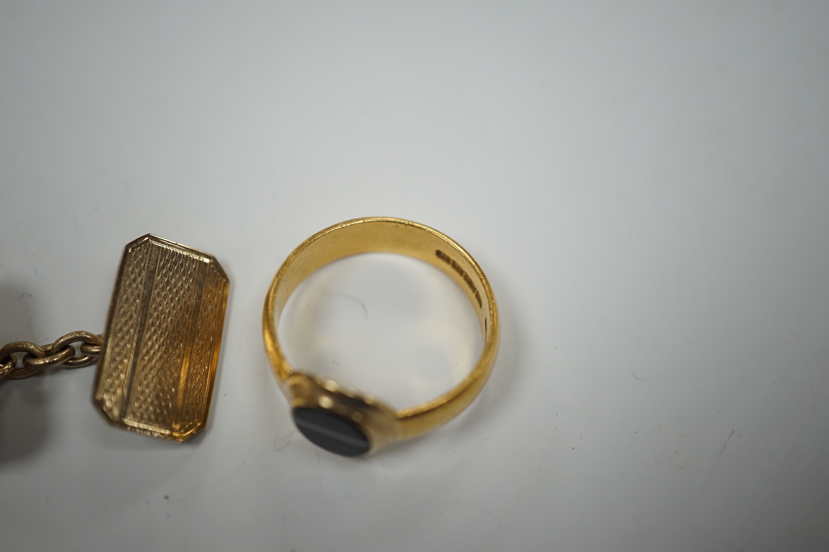 A 1930's part 22ct gold and banded black onyx set signet ring, (the ring head later associated), size Q/R, gross weight 6.8 grams, a pair of engine turned 9ct gold cufflinks, 8.5 grams and one other pair of cufflinks.